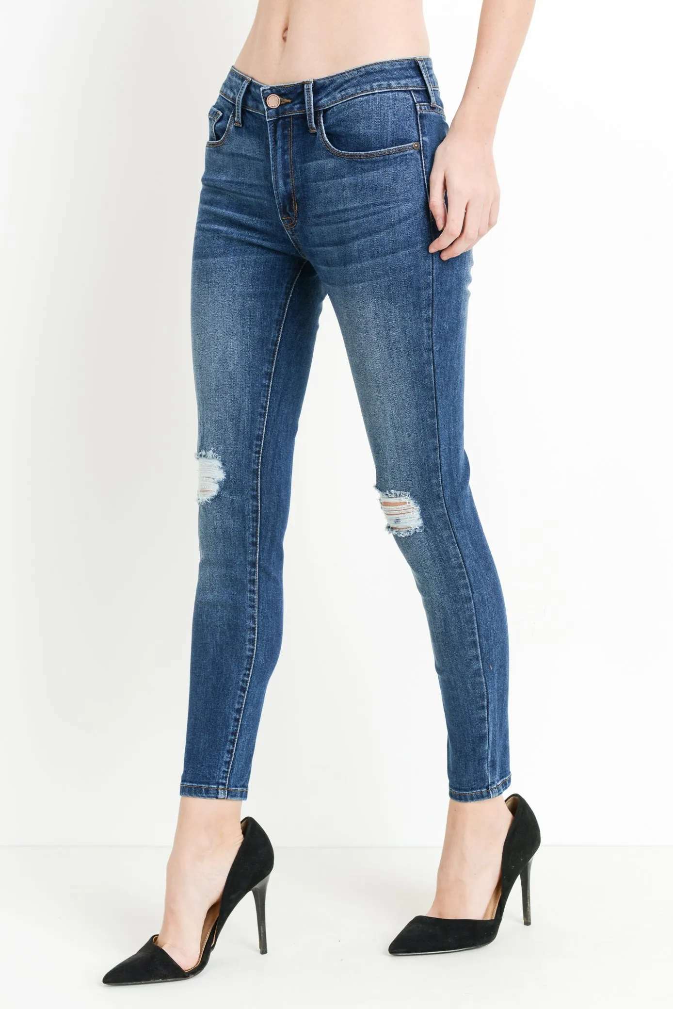 Mid rise dark denim skinny jeans with distressing